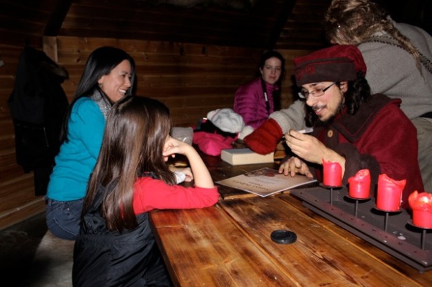 One of the elves signing our Santa's Helper Diploma!