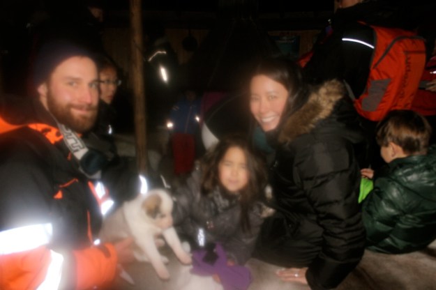 Meeting a cute husky puppy while thawing out by the fire after our sled ride!