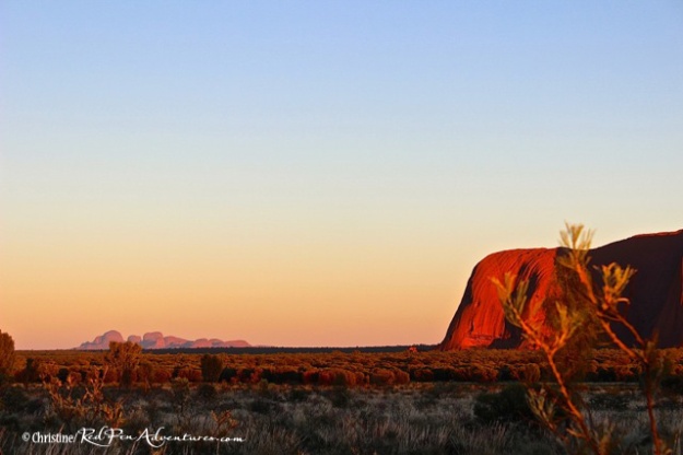 This shot shows the left end of Ayers Rock as well as a view of Kata Tjuta in the distance.